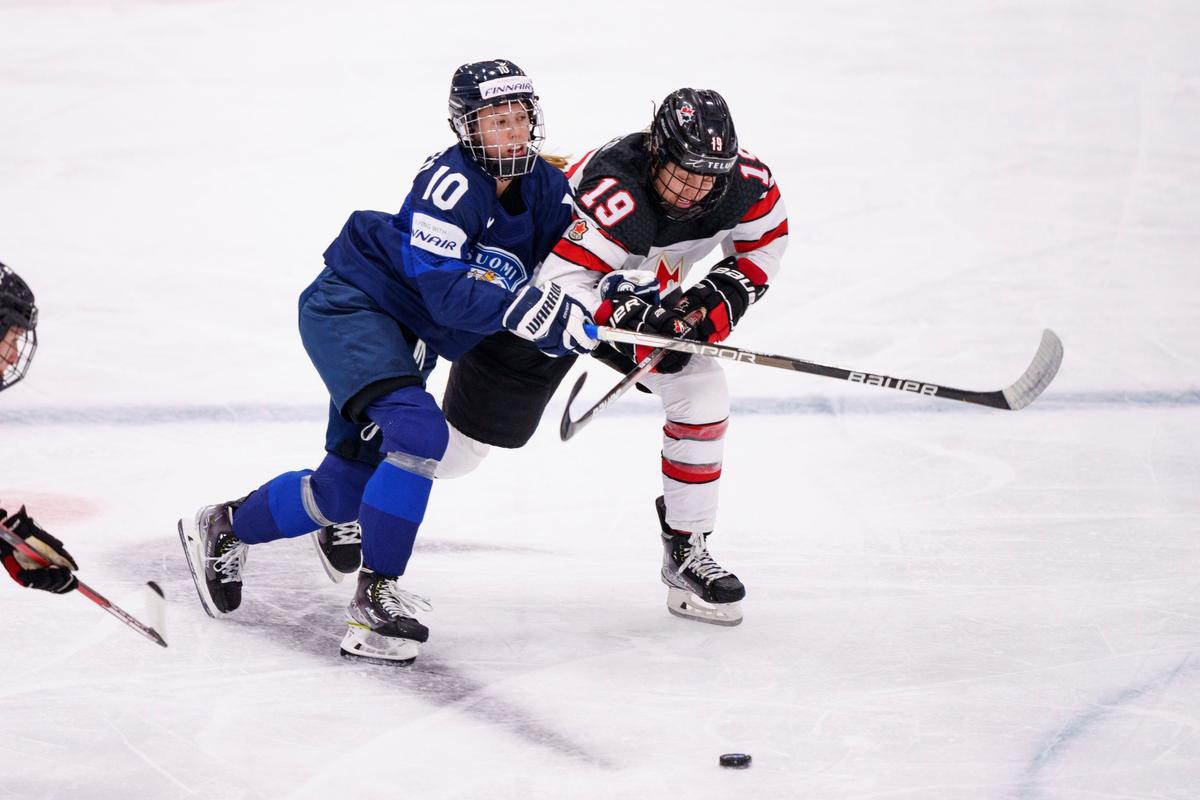 Elisa Holopainen of Finland in action with Brianne Jenner of Canada during the IIHF World Championship Women's ice hockey match between Finland and Canada in Herning, Denmark, on Aug. 25, 2022. (Bo Amstrup/Ritzau Scanpix via AP)