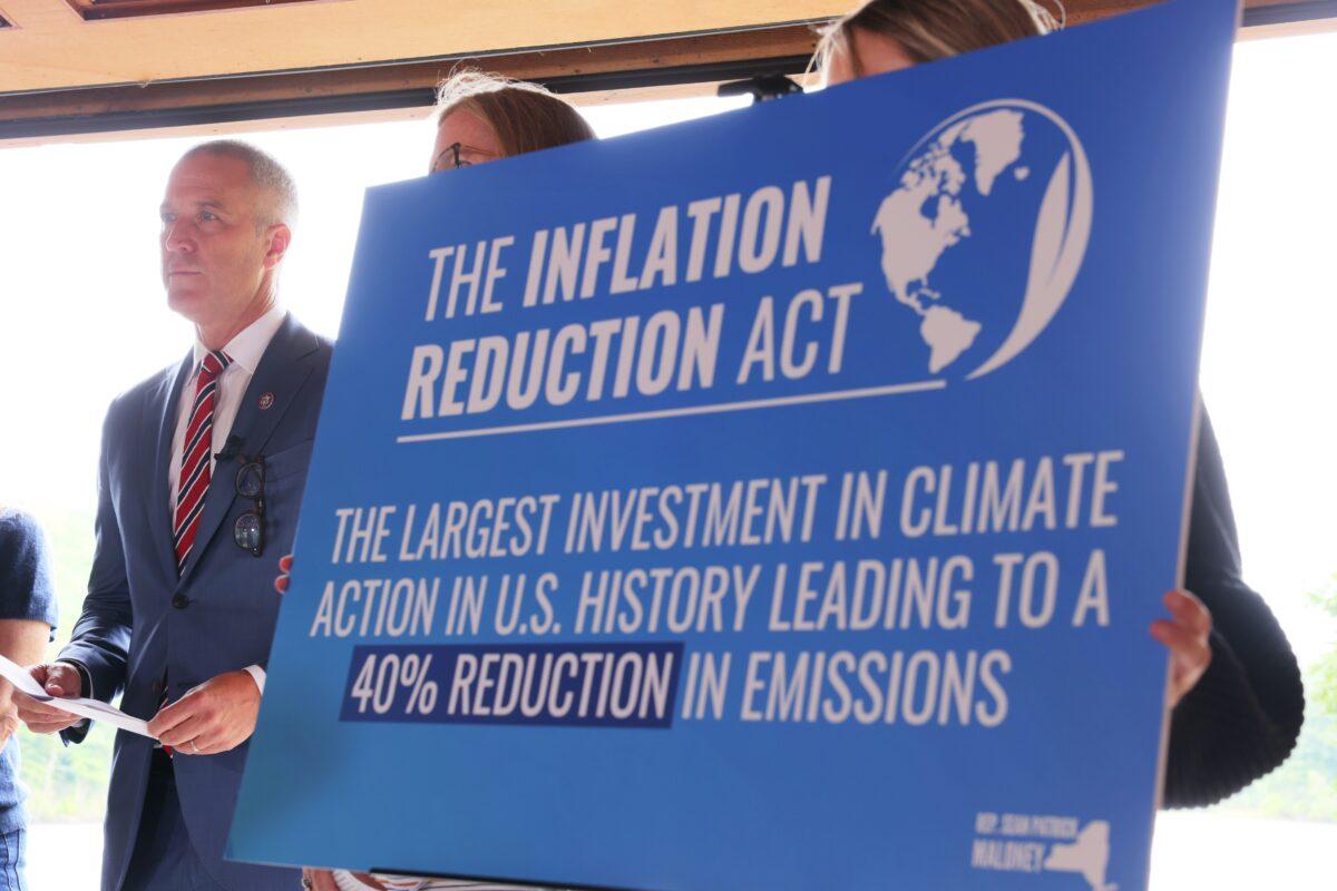 Rep. Sean Patrick Maloney (D-N.Y.) stands by a sign during a press conference on the Inflation Reduction Act at Glynwood Boat House in Cold Spring, New York, on Aug. 17, 2022. (Michael Santiago/Getty Images)