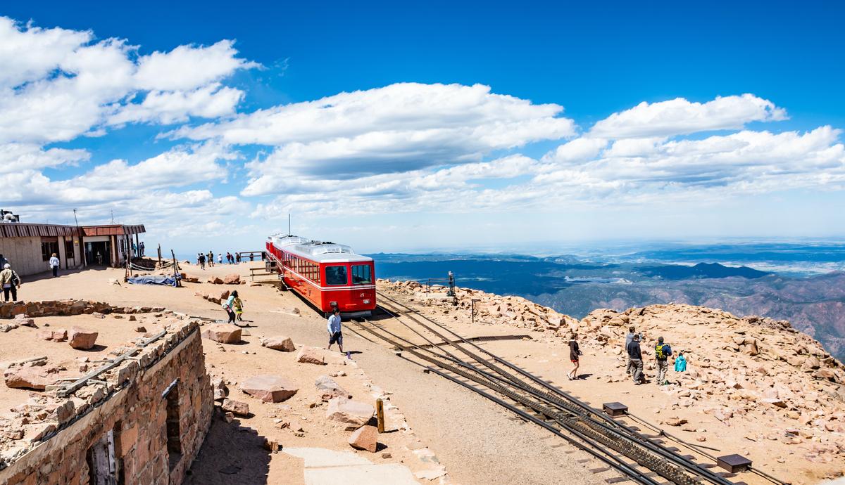 Cascade, Colorado, USA- July 11 2016. Pikes Peak Cog Railway car. People walking on top of Pikes Peak mountain in Pike National Forest. (Margaret.Wiktor/Shutterstock)