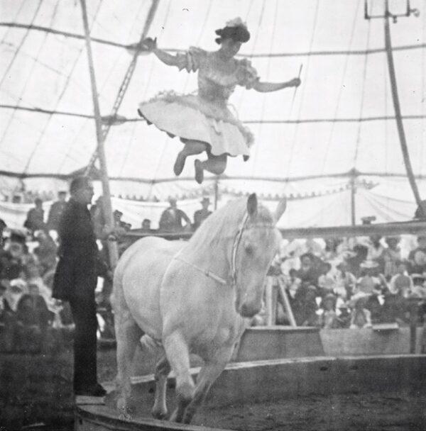 A circus performer shows off her equestrian skills. (Public domain)