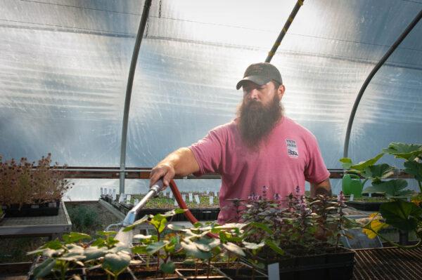 Greenhouse manager Duane Zbranek tends seed starts. (Courtesy of Vets on the Farm)