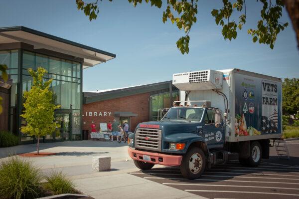 Big Dena and a mobile produce stand in front of the Spokane Public Library. (Courtesy of Vets on the Farm)