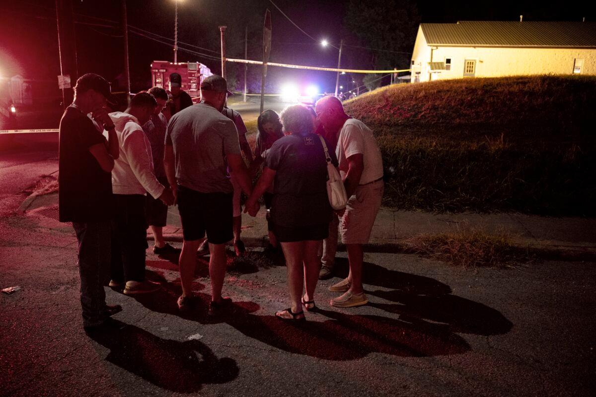 Residents and faculty of the Harbor House Christian Center in Henderson, Ky., gather in prayer after a lone gunman opened fire after an evening prayer service on Aug. 25, 2022. (Denny Simmons /The Gleaner via AP)