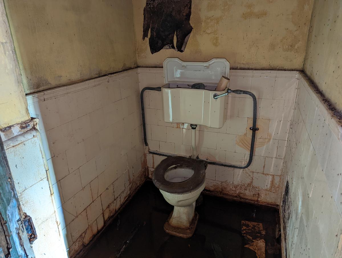 The remnants of a bathroom inside the abandoned WWII archives. (Courtesy of Caters News)