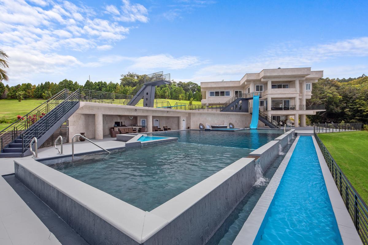 The lap pool lies next to the pool with its competition-ready dive platform, while the waterslide appeals to those seeking a thrill ride with a wet ending. (Sotheby's Concierge Auctions)