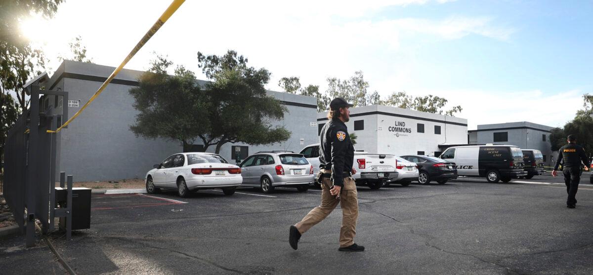 A Pima County constable walks into the crime scene at the Lind Commons Apartments in Tucson, Ariz., on Aug. 27, 2022. (Kelly Presnell/Arizona Daily Star via AP)
