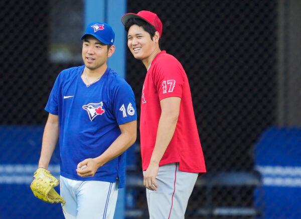 Shohei Ohtani #17 of the Los Angeles Angels and Yusei Kikuchi #16 of the Toronto Blue Jays speak during warm-up before their MLB game at the Rogers Centre in Toronto, Ontario, Canada, on August 26, 2022. (Mark Blinch/Getty Images)