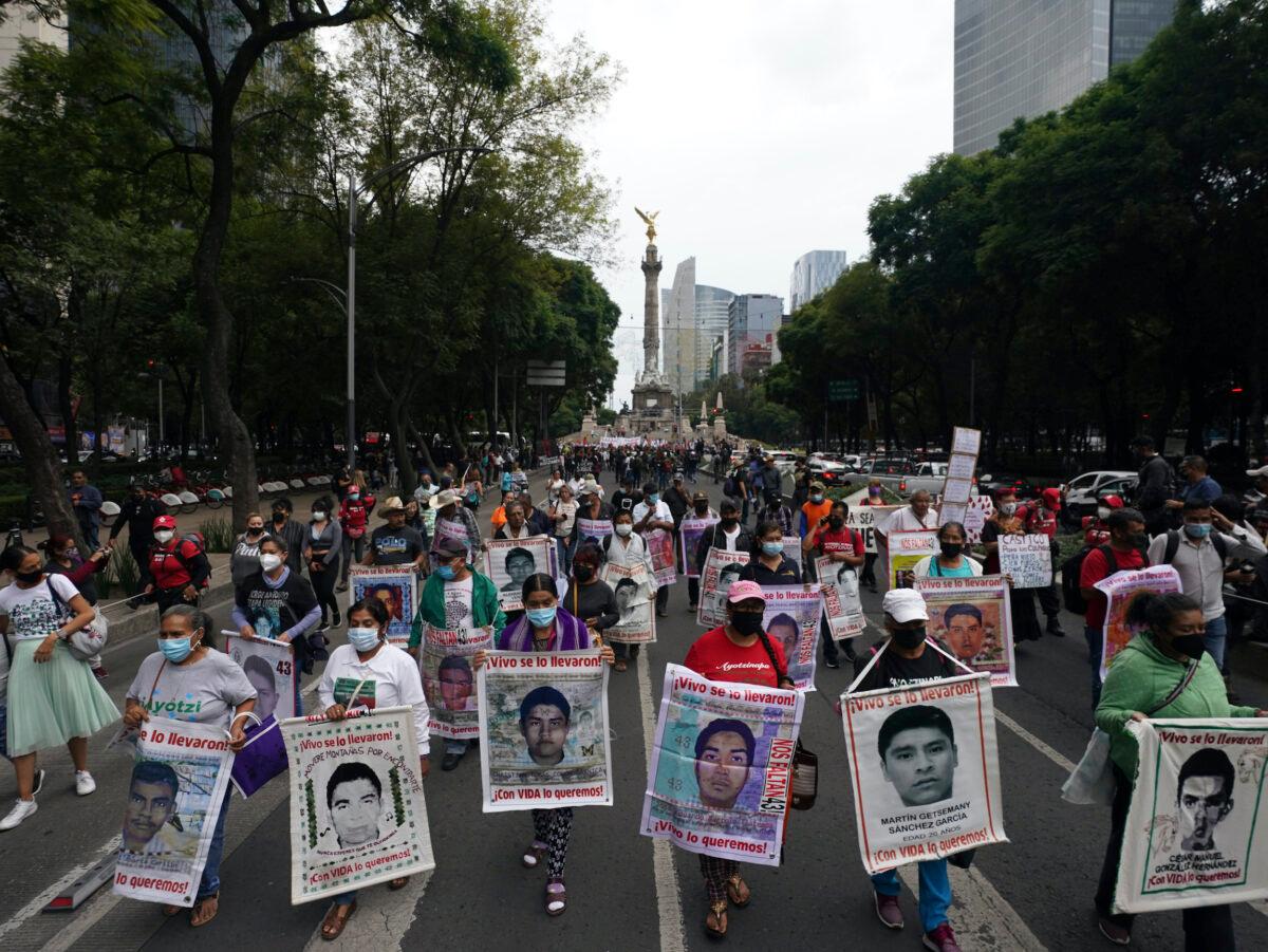 Family members and friends march seeking justice for the missing 43 Ayotzinapa students in Mexico City on Aug. 26, 2022. (Marco Ugarte/AP/Photo)