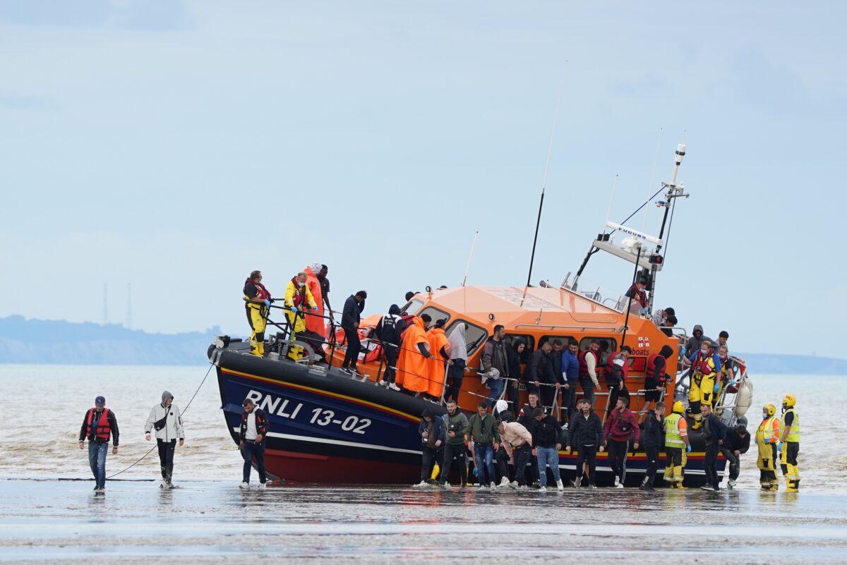A group of illegal immigrants are brought in to Dover, England, by the RNLI, on Aug. 25, 2022. (Gareth Fuller/PA Media)