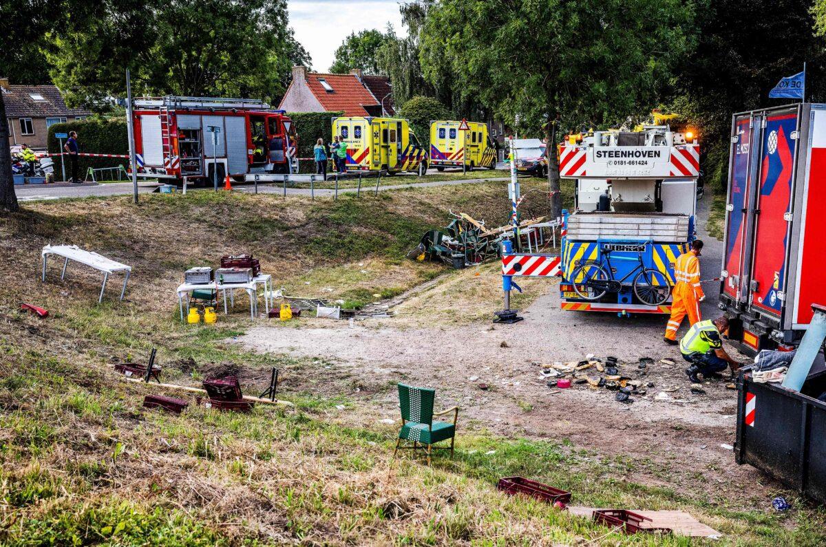 Emergency services operate at the scene of an accident after a lorry drove off a dike into a neighborhood party, killing at least two attendees and injuring several others, in Nieuw-Beijerland, Netherlands, on Aug. 27, 2022. (STR/ANP/AFP via Getty Images)