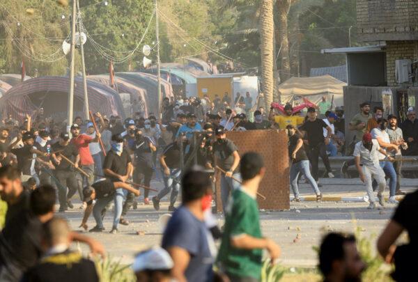 Supporters of Iraqi populist leader Moqtada al-Sadr clash with supporters of the Coordination Framework, a group of Shi'ite parties, at the Green Zone in Baghdad, Iraq, on Aug. 29, 2022. (Thaier Al-Sudani/Reuters)