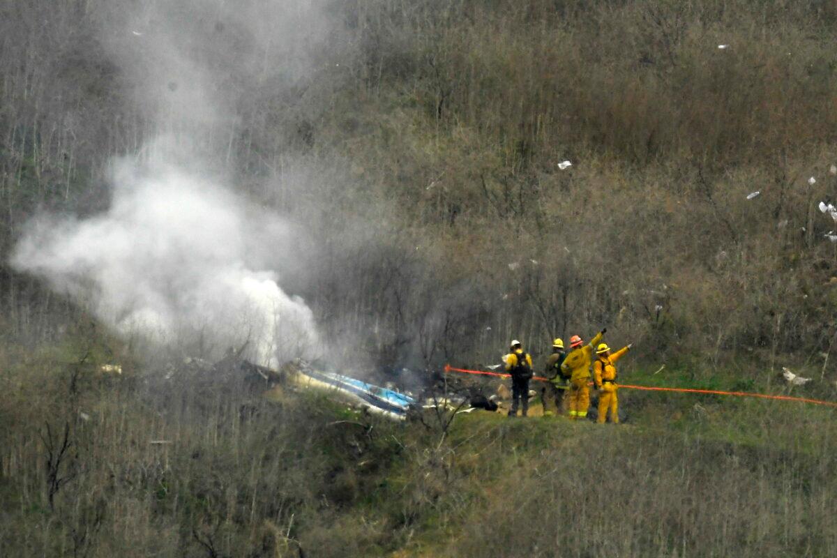Firefighters work the scene of a helicopter crash where former NBA basketball star Kobe Bryant died in Calabasas, Calif., on Jan. 26, 2020. (Mark J. Terrill/AP Photo)