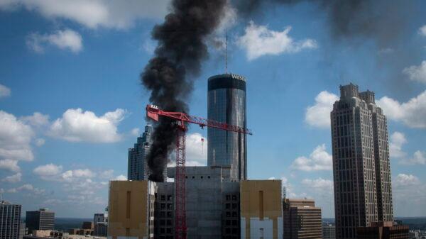 Black smoke from a fire atop a building under construction in Atlanta on Aug. 31, 2022. (Ron Harris/AP Photo)
