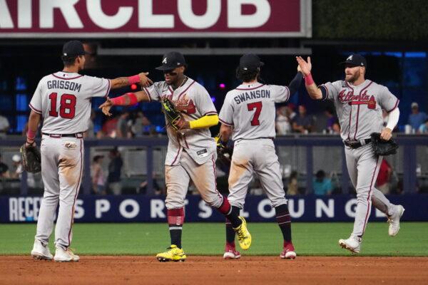 Atlanta Braves second baseman Vaughn Grissom (18), right fielder Ronald Acuna Jr. (13), shortstop Dansby Swanson (7) and left fielder Robbie Grossman (15) celebrate after defeating the Miami Marlins in game one of a double header at loanDepot park in Miami, on Aug. 13, 2022. (Jasen Vinlove/USA TODAY Sports via Reuters)