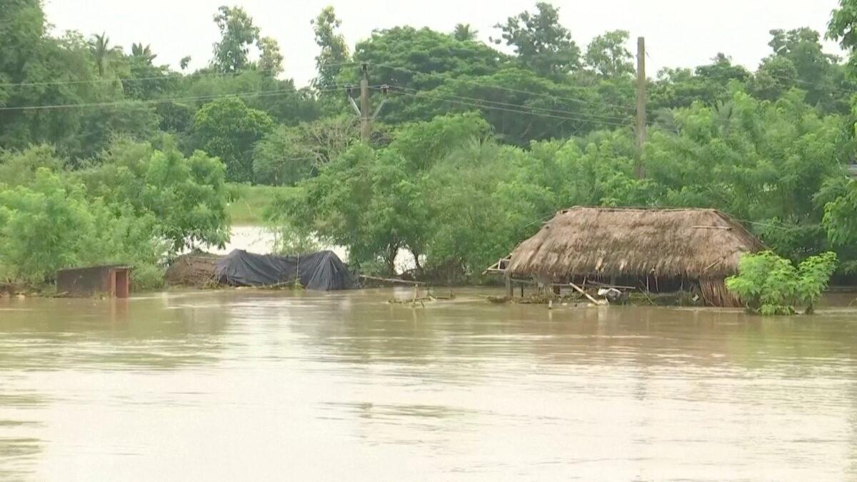 Huts get partially submerged in floodwater following heavy rains in Jagatsinghpur, Odisha, India, on Aug. 20, 2022, in a screenshot from video. (ANI via Reuters)