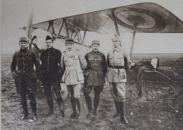 Three of the airmen of the American squadron who fell gloriously for France (dark uniforms from left to right): James Rogers McConnell, Kiffin Rockwell, and Norman Prince. This photograph was published in a French newspaper on Nov. 19, 1916. (Public Domain)