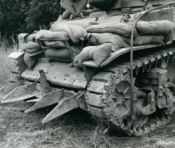  A Culin hedgerow cutter made from German blocks (landing obstructions) is affixed to a light tank. (Public domain)