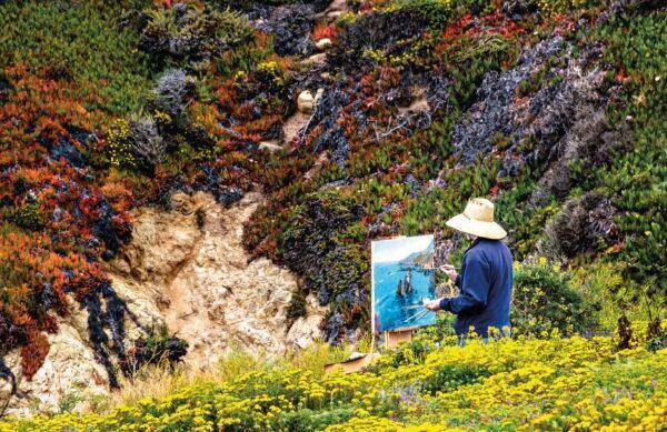 An artist paints amid wildflowers at Garrapata State Park. (Maria Coulson)
