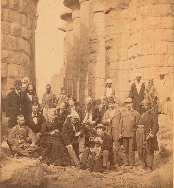 Grant and Julia (seated left of center) pose alongside their guides and porters at the Karnak Temple Complex near the ancient city of Thebes, January 1878. (Public domain)