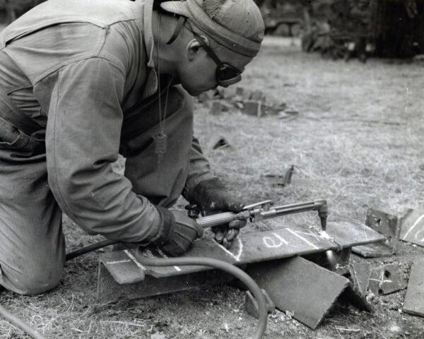  Soldier makes a plowshare to affix to a tank for plowing hedgerows in Normandy. (Public domain)