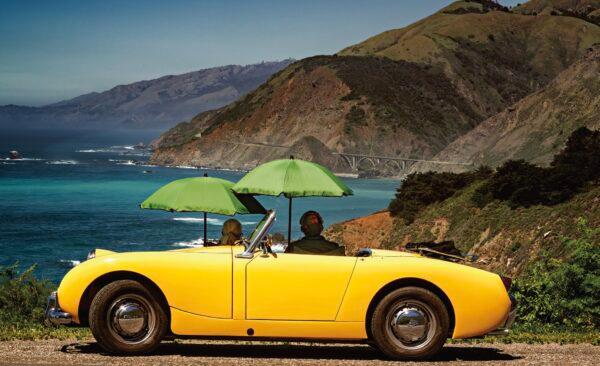 A 1960 Austin- Healey parked along California’s Highway 1, overlooking Bixby Bridge in the distance. (Maria Coulson)