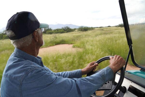 Ranch owner Joe Scelso surveys a section of his property in Hereford, Ariz., from his all-terrain vehicle on Aug. 24. (Allan Stein/The Epoch Times)