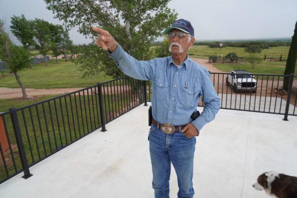 Rancher Joe Scelso points to where he's encountered illegal aliens on his property from the deck above his car port on Aug. 24. (Allan Stein/The Epoch Times)