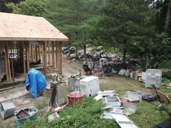 Flood debris and items that may be reused surround the twice flooded Cockerham home in Beattyville, Kentucky. (Courtesy Allie Marshall)