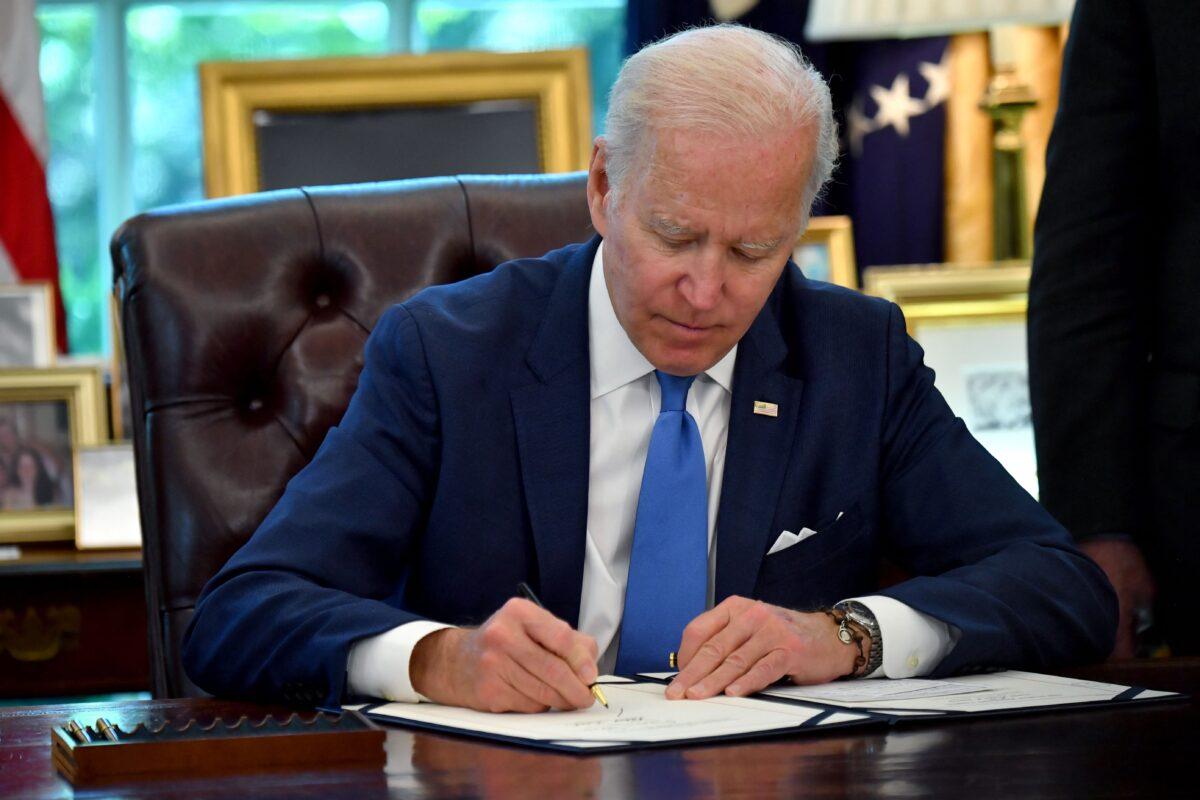 President Joe Biden signs into law the Ukraine Democracy Defense Lend-Lease Act of 2022, in the Oval Office of the White House in Washington, on May 9, 2022. (Nicholas Kamm/AFP via Getty Images)