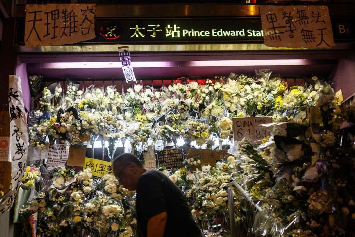 Outside an exit of the Prince Edward MTR Station, citizens covered the exit with flowers for the people who they believed had died that night. (Philip Fong/AFP/Getty Image)
