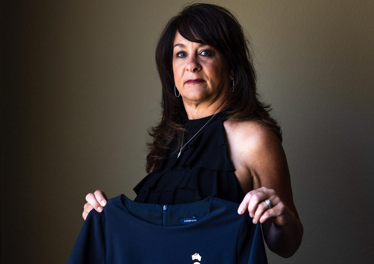 Charlene Carter holds her former Southwest Airlines flight attendant's uniform at her home in Aurora, Colo., on Aug. 30, 2022. (Michael Ciaglo/The Epoch Times)