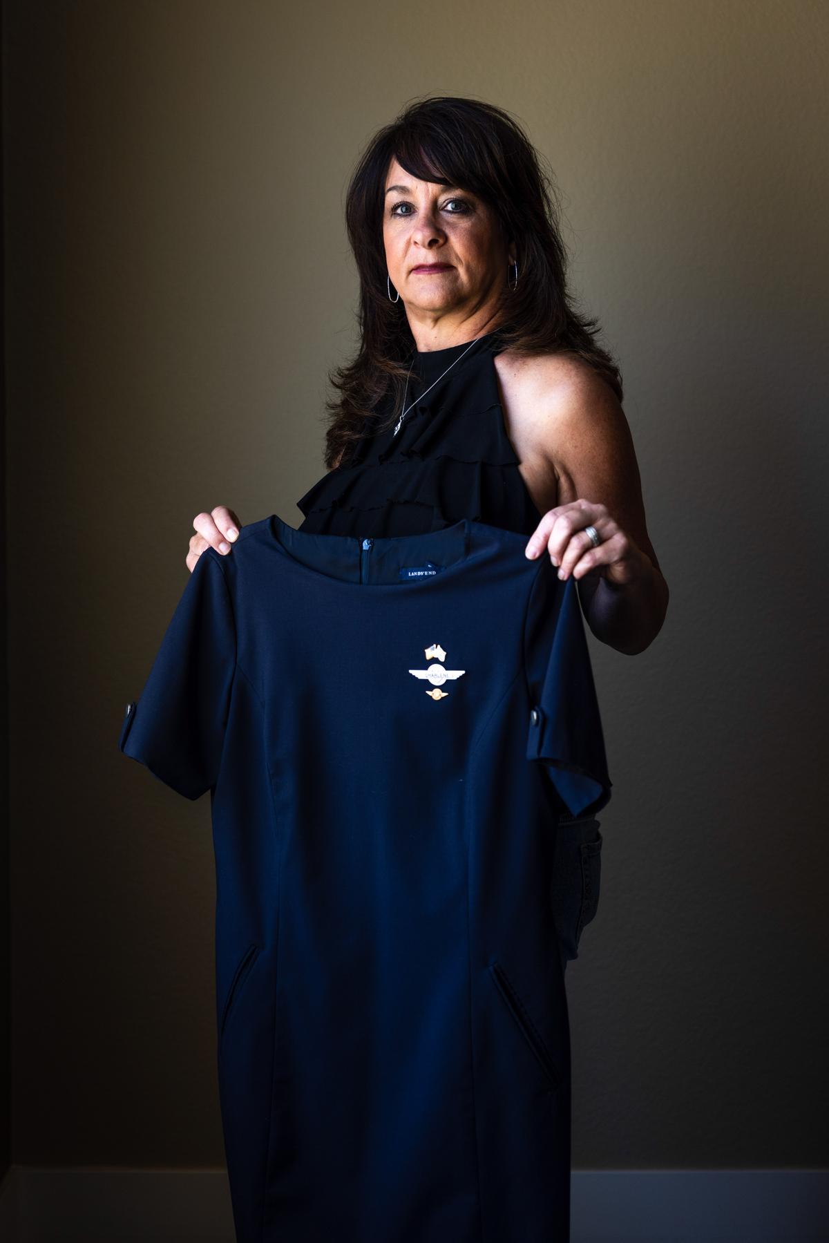 Charlene Carter holds her former Southwest Airlines flight attendant's uniform at her home in Aurora, Colo., on Aug. 30, 2022. (Michael Ciaglo for The Epoch Times)
