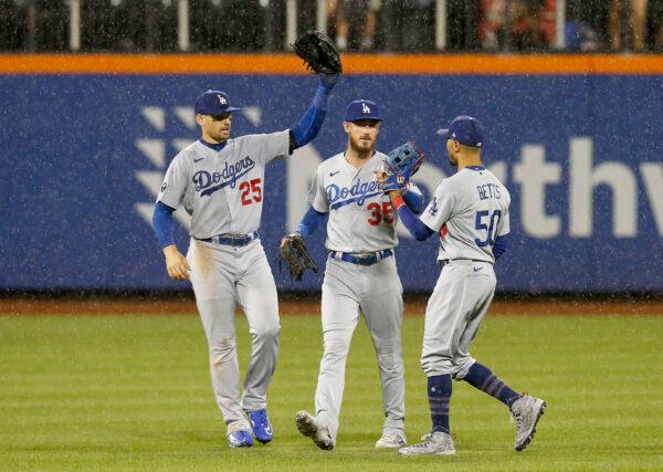 Trayce Thompson (25), Cody Bellinger (35) and Mookie Betts (50) of the Los Angeles Dodgers celebrate after defeating the New York Mets at Citi Field in New York, Aug. 30, 2022. (Jim McIsaac/Getty Images)