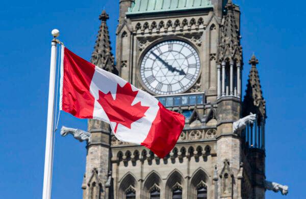  The Canadian flag flies near the Peace Tower on Parliament Hill in Ottawa in a file photo. (Adrian Wyld/The Canadian Press)
