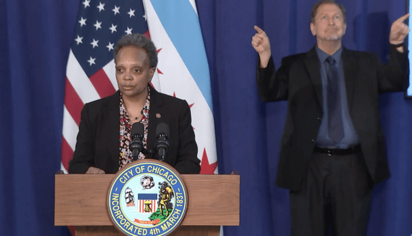  Chicago Mayor Lori Lightfoot joins City Council members and community leaders for the signing of the Welcoming City Ordinance in Chicago, on Feb. 23, 2021. (Screenshot via The Epoch Times)