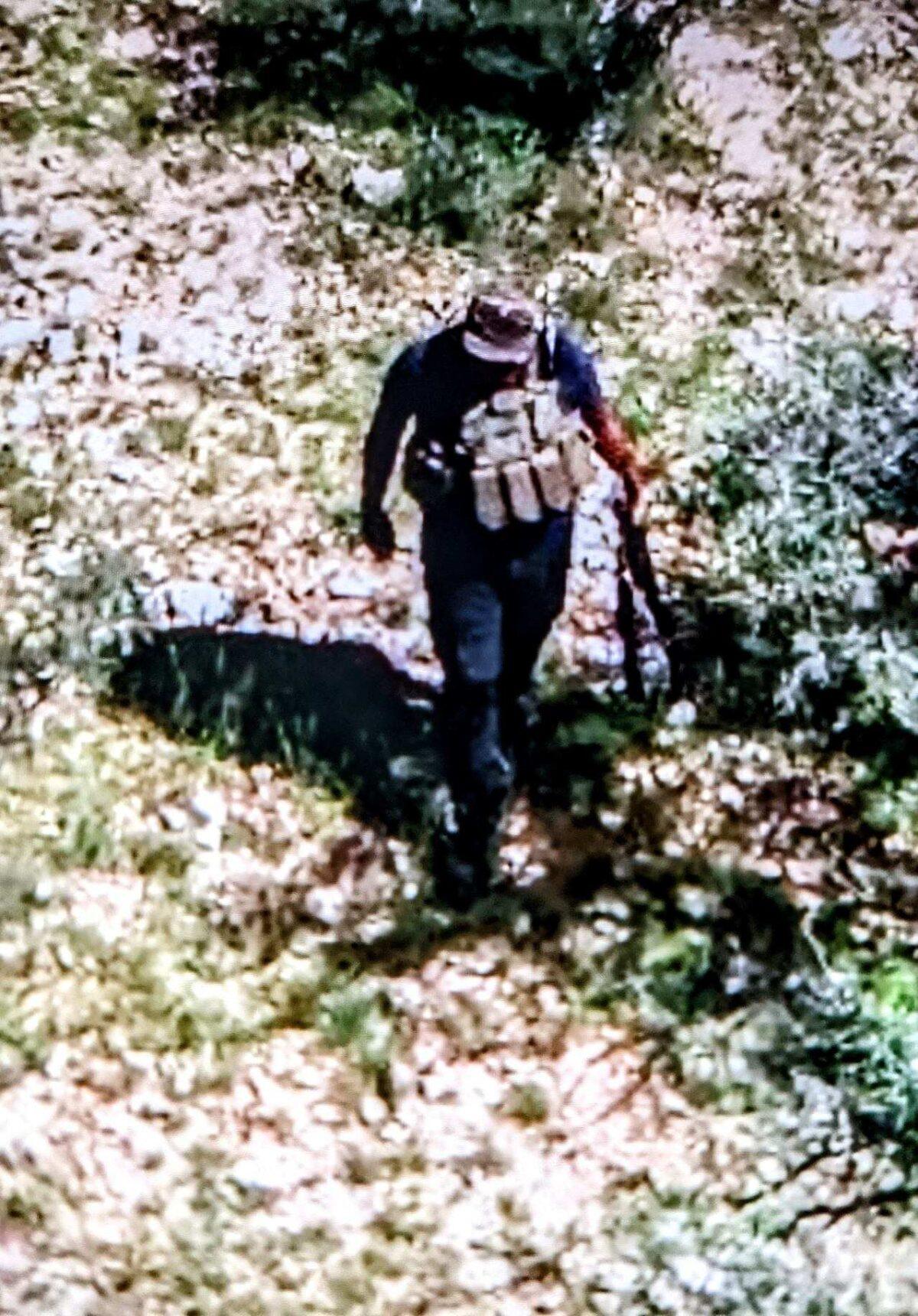 Closeup drone footage shows a heavily armed Mexican drug cartel member walking near Arizona's border with Mexico on Aug. 25. Seconds later, the man took aim at the drone with his rifle hoping to shoot it down. (Photos courtesy Arizona private security company)