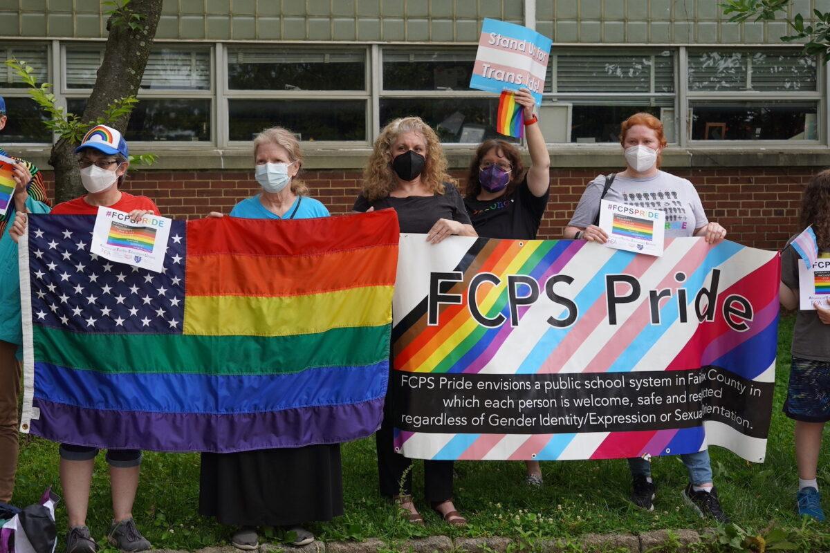 LGBT activists show support for Fairfax County Public Schools' pro-transgender policies outside the Luther Jackson Middle School in Falls Church, Va., on June 16, 2022. (Terri Wu/The Epoch Times)