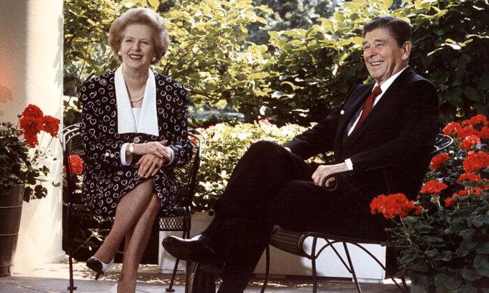 President Ronald Reagan and British Prime Minister Margaret Thatcher pose for photographers on the patio outside the Oval Office in Washington on July 17, 1987. (Mike Sargent/AFP via Getty Images)