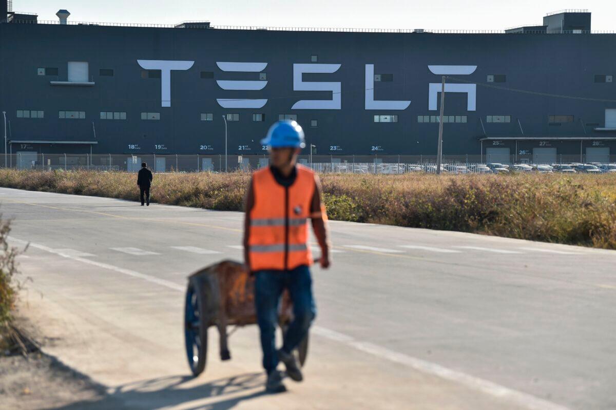 A worker walks near Tesla's "Gigafactory," in Shanghai on November 8, 2019. (Hector Retamal/AFP via Getty Images)
