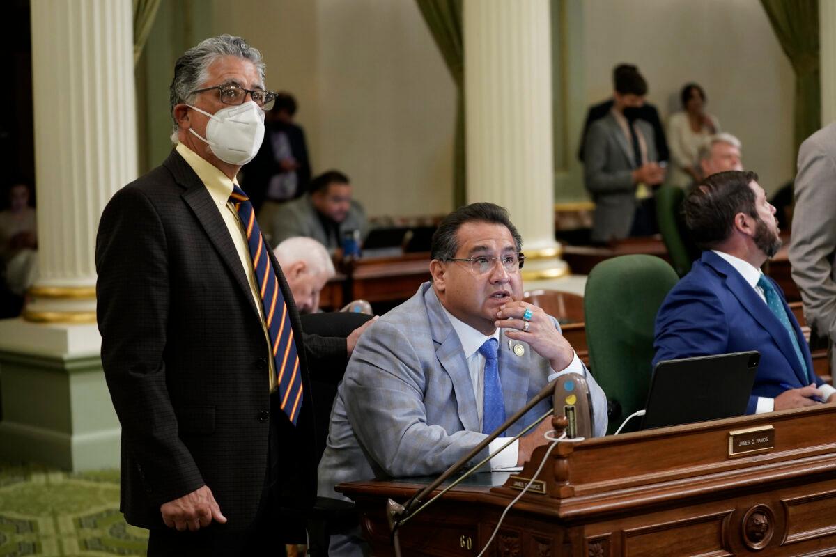 State Sen. Anthony Portantino, left, and Assemblyman James Ramos watch as the votes are posted on a gun control measure at the Capitol in Sacramento, Calif., on Aug. 30, 2022. (Rich Pedroncelli/AP Photo)