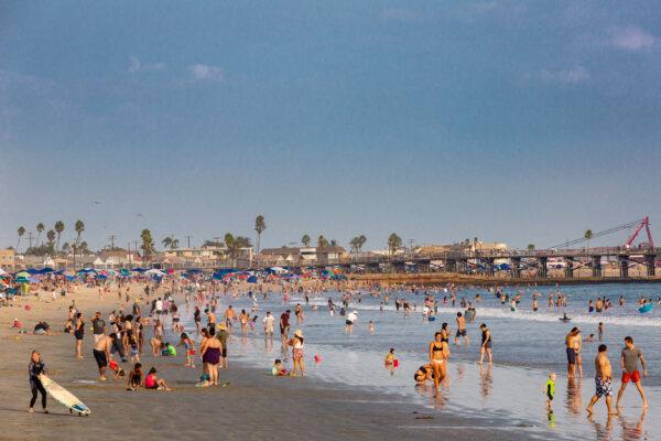 Beachgoers enjoy cooling off in the ocean in Seal Beach, Calif., on Sept. 6, 2020. (John Fredricks/The Epoch Times)