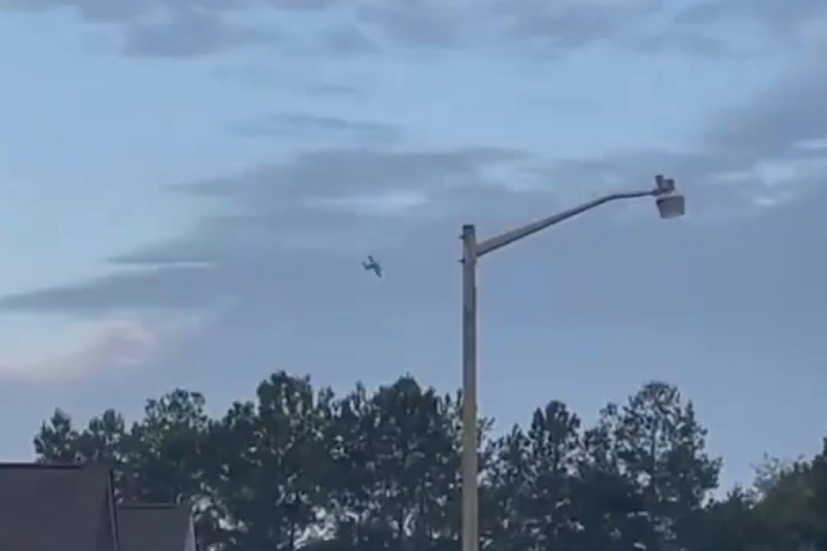 A small airplane circles over Tupelo, Miss., on Sept. 3, 2022. Police say the pilot of the small airplane is threatening to crash the aircraft into a Walmart store. The Tupelo Police Department said that the Walmart and a nearby convenience store had been evacuated. (WCBI-TV via AP)