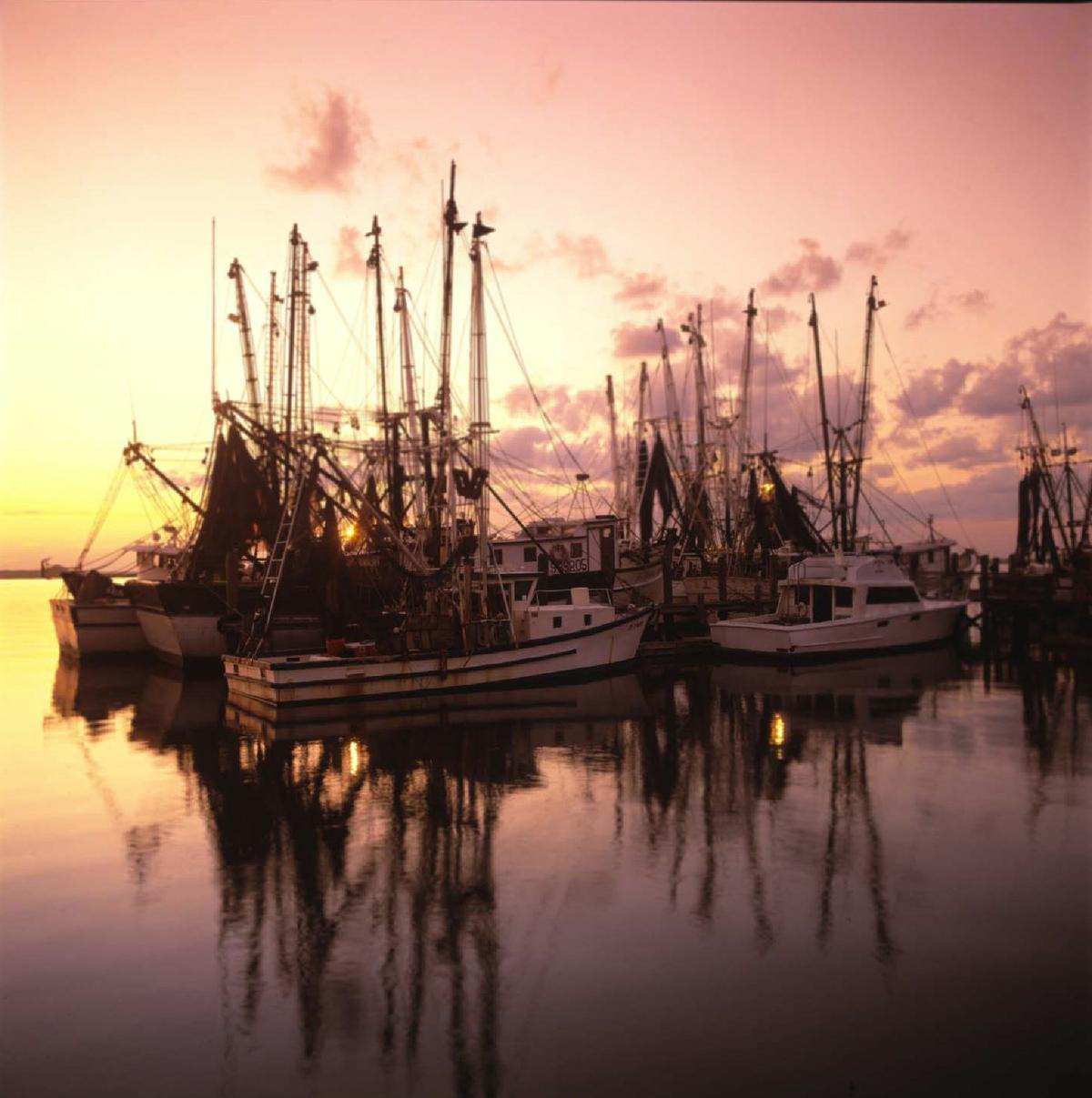 A sunset behind shrimp boats emphasizes the beauty of Amelia Island, Florida. (Photo courtesy of Victor Block.)