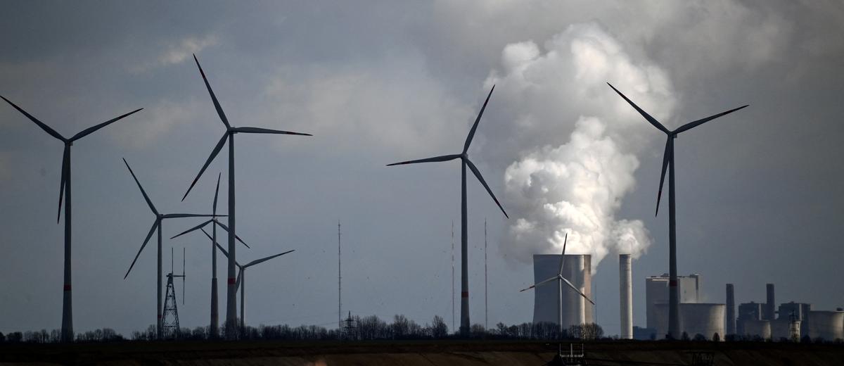  Wind turbines are seen near the coal-fired power station Neurath of German energy giant RWE in Garzweiler, western Germany, on March 15, 2021. (Ina Fassbender/AFP via Getty Images)