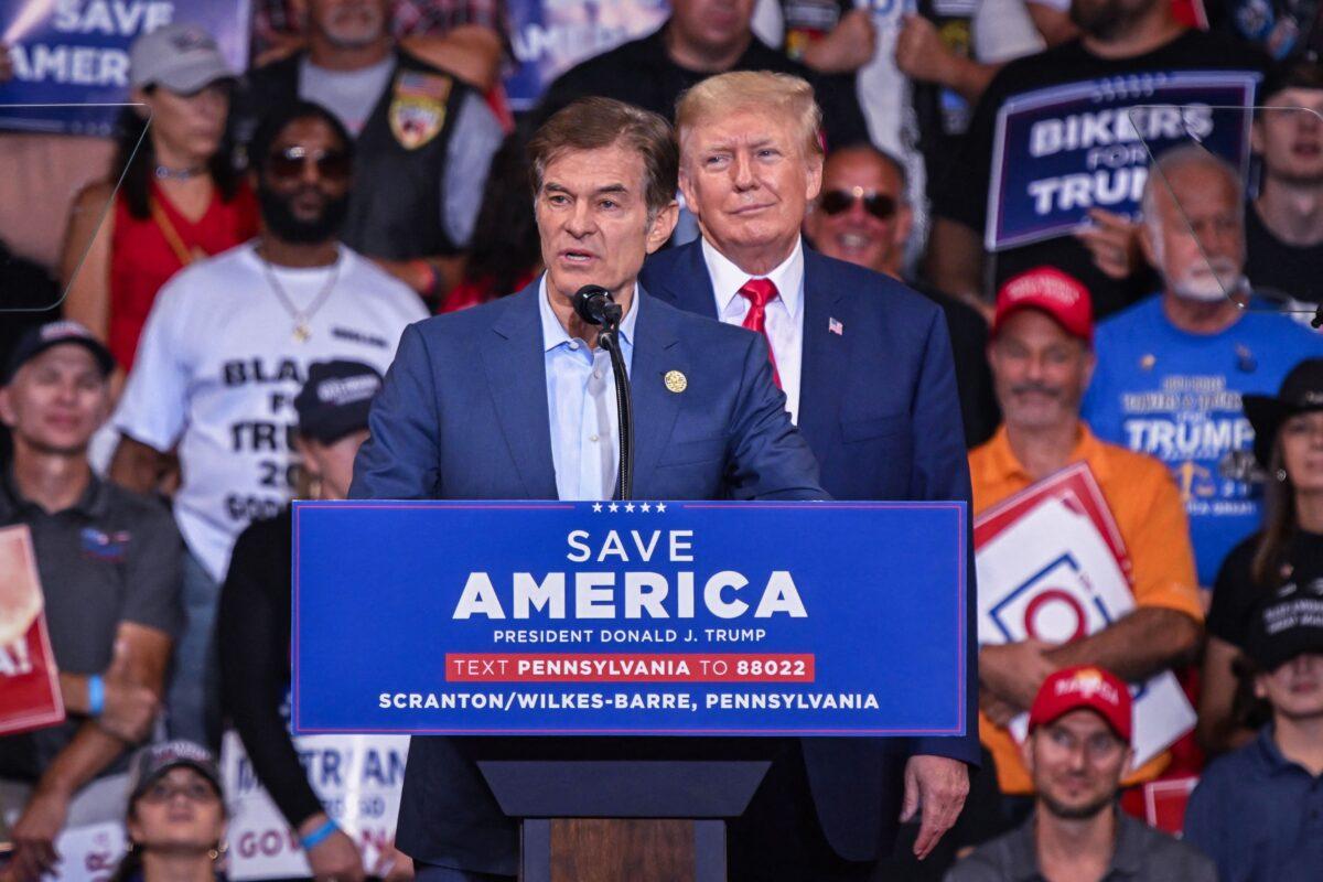 Mehmet Oz, who is running for the U.S. Senate, speaks as former U.S. President Donald Trump stands behind him during a campaign rally at Mohegan Sun Arena in Wilkes-Barre, Pennsylvania, on Sept. 3, 2022. (Ed Jones/AFP via Getty Images)