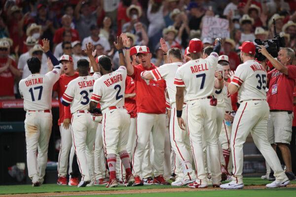 The Los Angeles Angels celebrate their win in the twelfth inning over the Houston Astros at Angel Stadium of Anaheim, in Anaheim, Calif., on Sept. 3, 2022. (Meg Oliphant/Getty Images)