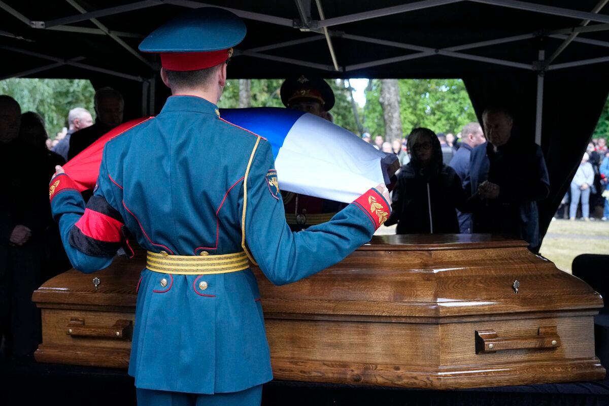 Honor guards remove a Russian flag from the coffin of former Soviet leader Mikhail Gorbachev during his funeral at Novodevichy Cemetery in Moscow, on Sept. 3, 2022. (Alexander Zemlianichenko/AP Photo, Pool)