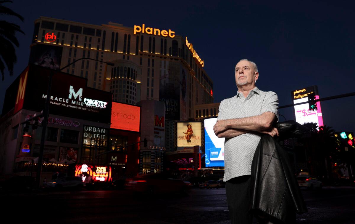Jeff German, host of "Mobbed Up," poses with Planet Hollywood, formerly the Aladdin, in the background on the Strip in Las Vegas on June 2, 2021. (K.M. Cannon/Las Vegas Review-Journal via AP)