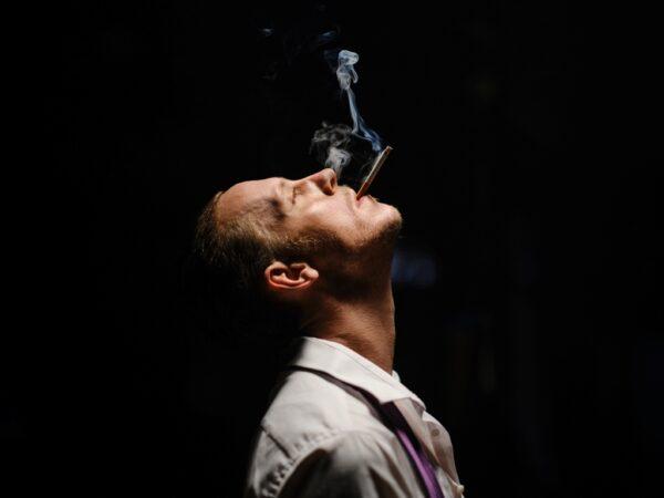 Laurence Fox as Hunter Biden smokes crack in a roll of money in a scene from "My Son Hunter." (The Unreported Story Society)