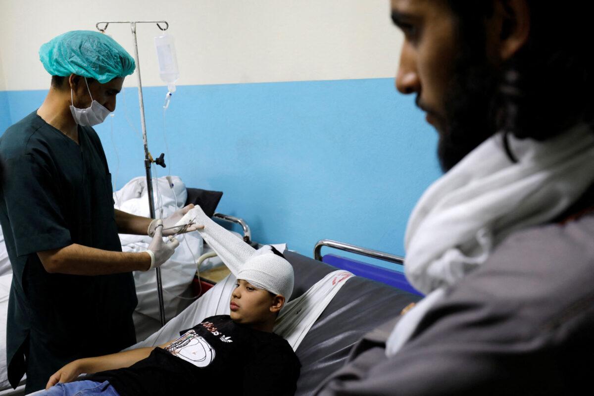 A boy who was wounded after a suicide bomber detonated explosives near the entrance of the Russian embassy, is treated inside a hospital in Kabul, Afghanistan, on Sept. 5, 2022. (Ali Khara/Reuters)